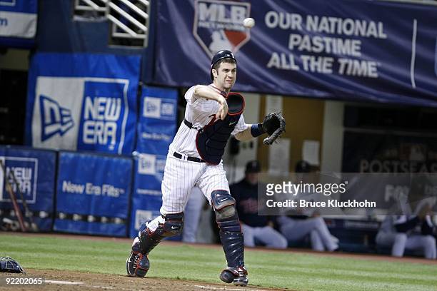 Joe Mauer of the Minnesota Twins throws to first against the New York Yankees on October 11, 2009 at the Metrodome in Minneapolis, Minnesota. The New...