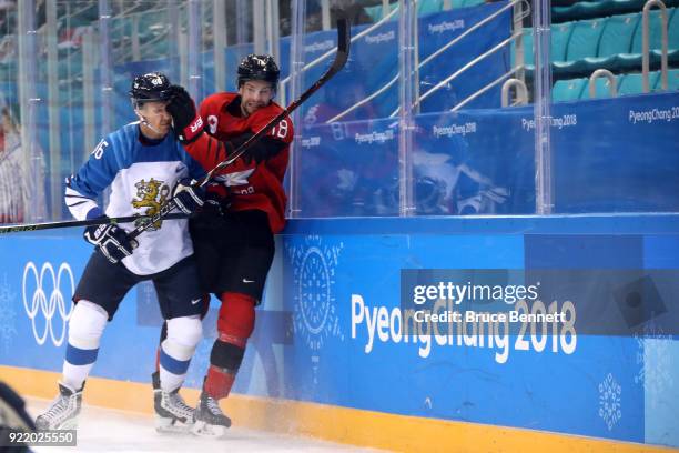 Veli-Matti Savinainen of Finland collides with Marc-Andre Gragnani of Canada in the first period during the Men's Play-offs Quarterfinals on day...
