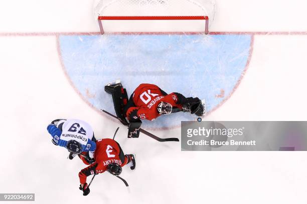 Ben Scrivens of Canada makes a save against Joonas Kemppainen of Finland in the first period during the Men's Play-offs Quarterfinals on day twelve...