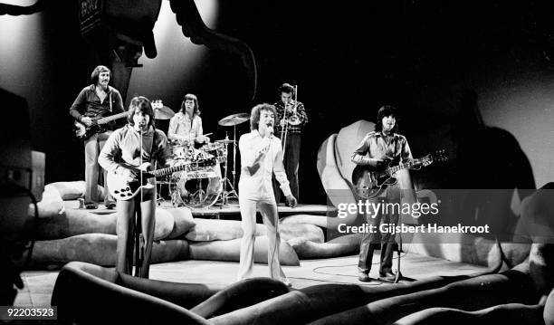 The Hollies perform live in Hilversum, Holland in 1974 L-R Bernie Calvert, Tony Hicks, Bobby Elliott, Allan Clarke, trombone player, Terry Sylvester