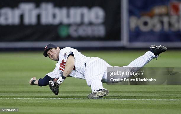 Nick Punto of the Minnesota Twins fields a ball too late for the putout against the New York Yankees on October 11, 2009 at the Metrodome in...