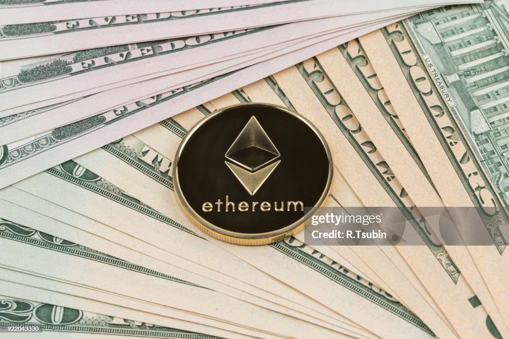 Golden ethereum coin on a paper dollars