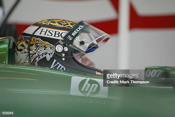Eddie Irvine of Northern Ireland and Jaguar checks his lap times during qualifying for the British Grand Prix at Silverstone on July 6, 2002 at...
