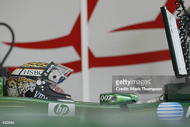 Eddie Irvine of Northern Ireland and Jaguar checks his lap times during qualifying for the British Grand Prix at Silverstone on July 6, 2002 at...