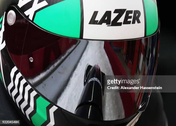 The sled is reflected in the visor of Seun Adigun of Nigeria as she and Akuoma Omeoga slide during the Women's Bobsleigh heats on day twelve of the...