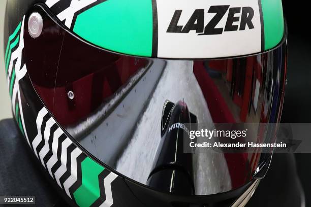 The sled is reflected in the visor of Seun Adigun of Nigeria as she and Akuoma Omeoga slide during the Women's Bobsleigh heats on day twelve of the...