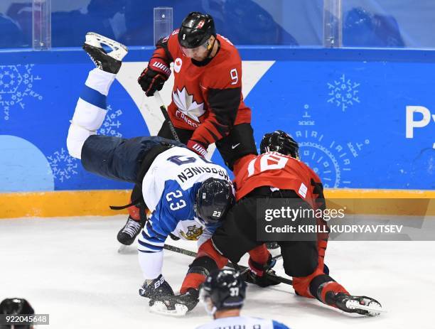 Finland's Joonas Kemppainen falls over Canada's Derek Roy , and Canada's Marc-Andre Gragnani in the men's quarter-final ice hockey match between...