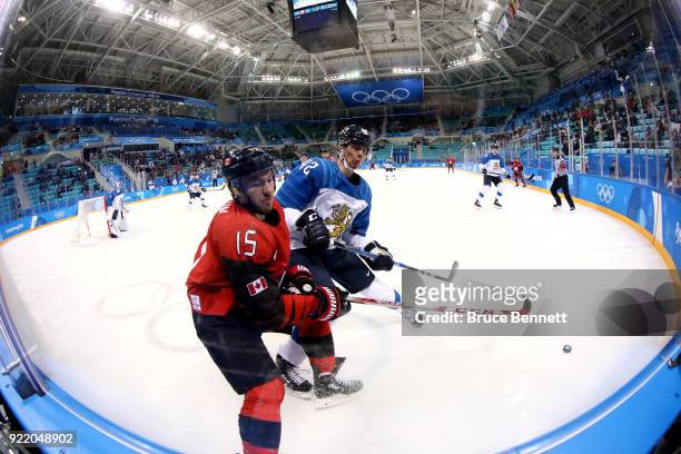 Brandon Kozun of Canada competes for the puck with Miro Heiskanen of Finland in the first period during the Men's Play-offs Quarterfinals on day...