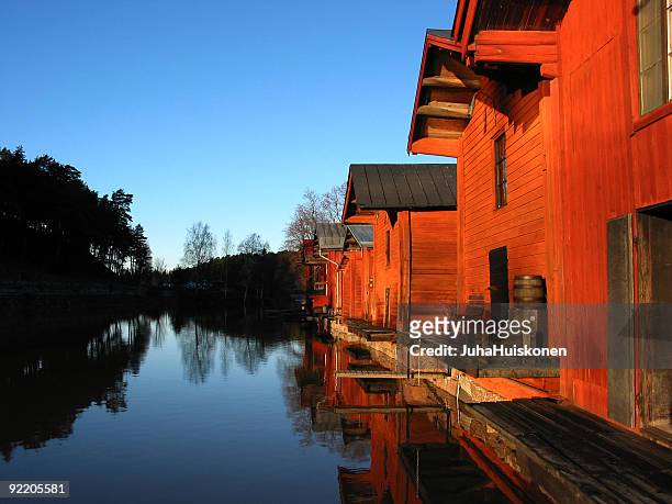 vivid red and blue river scene - porvoo stockfoto's en -beelden