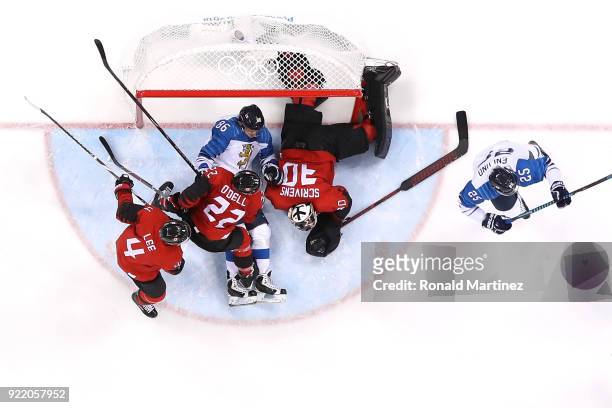 Veli-Matti Savinainen of Finland collides with Ben Scrivens of Canada in the second period during the Men's Play-offs Quarterfinals on day twelve of...