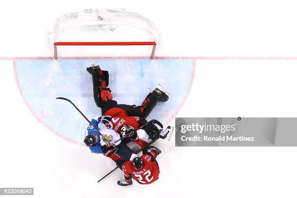 Veli-Matti Savinainen of Finland collides with Ben Scrivens of Canada in the second period during the Men's Play-offs Quarterfinals on day twelve of...