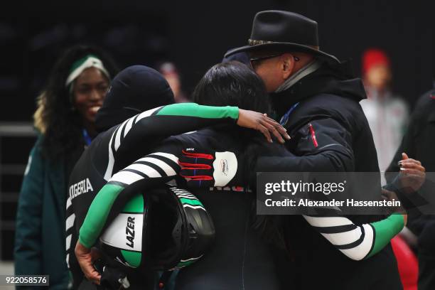 Jazmine Fenlator-Victorian and Carrie Russell of Jamaica react with President of the International Bobsleigh Federation Ivo Ferriani in the finish...