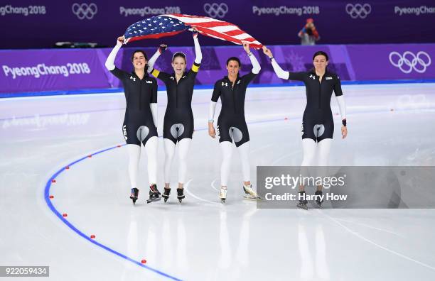 Heather Bergsma, Brittany Bowe, Mia Manganello and Carlijn Schoutens of the United States celebrate after winning the bronze medal in the Speed...