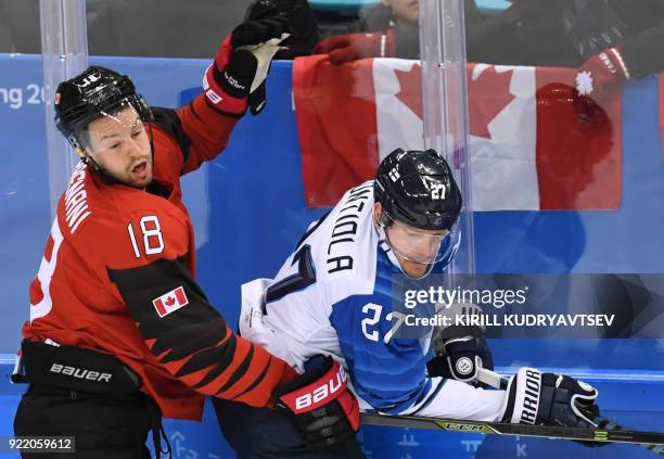 Canada's Marc-Andre Gragnani clashes with Finland's Petri Kontiola in the men's quarter-final ice hockey match between Finland and Canada during the...
