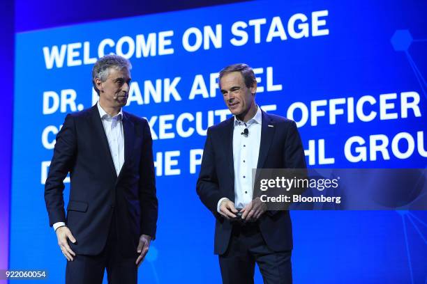 Frank Appel, chief executive officer of Deutsche Post AG, left, stands on stage with Volkmar Denner, chief executive officer of Robert Bosch GmbH,...