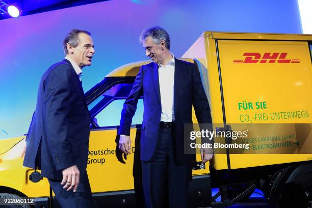 Volkmar Denner, chief executive officer of Robert Bosch GmbH, left, and Frank Appel, chief executive officer of Deutsche Post AG, stand beside a DHL...