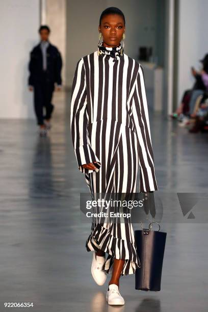 Model walks the runway at the Mother of Pearl show during London Fashion Week February 2018 at Newport Street Gallery on February 19, 2018 in London,...