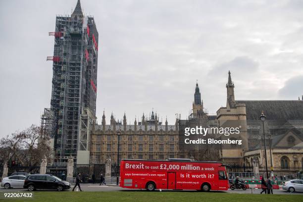 Bus with the campaign motto: "Brexit to cost £2,000 million a week says government's own report. Is it worth it?" passes the Houses of Parliament in...