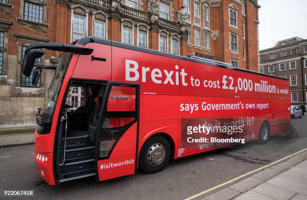 Bus with the campaign motto: "Brexit to cost £2,000 million a week says government's own report. Is it worth it?" stands on a street during its...