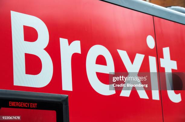 Bus with the campaign motto: "Brexit to cost £2,000 million a week says government's own report. Is it worth it?" sits parked on a street as the...