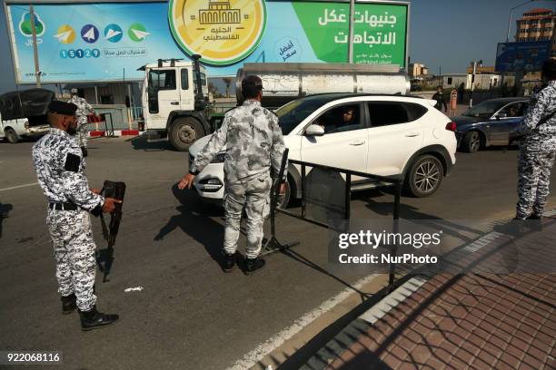 Palestinian members of Hamas security forces stop a vehicle at a security checkpoint in Gaza City on February 21, 2018.