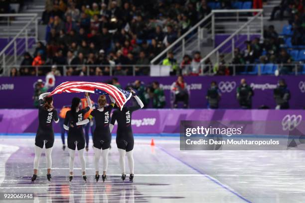 Heather Bergsma, Brittany Bowe, Mia Manganello and Carlijn Schoutens of the United States celebrate after winning the bronze medal in the Speed...