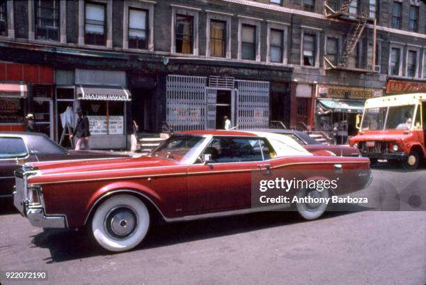 View of a customized Lincoln-Continental Mark III 'pimpmobile' on a street in Harlem, New York, New York, 1970s.