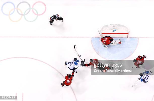 Mika Pyorala of Finland attempts a shot against Cody Goloubef and Kevin Poulin of Canada in the second period during the Men's Play-offs...