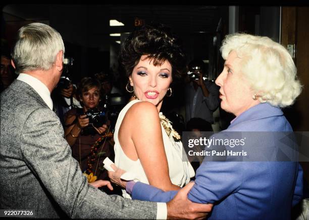 Aaron Spelling, Joan Collins and Barbara Stanwyck at a party at a Beverly Hills Hotel on December 16 ,1983 in Beverly Hills, California