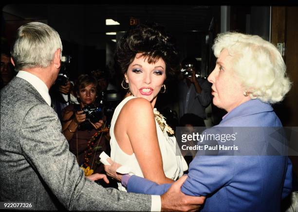 Aaron Spelling, Joan Collins and Barbara Stanwyck at a party at a Beverly Hills Hotel on December 16 ,1983 in Beverly Hills, California
