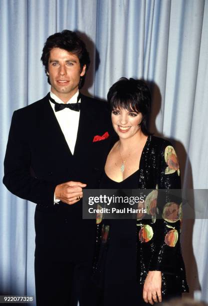 Actor John Travolta and actress and host Liza Minnelli pose backstage during the 55th Academy Awards April 11, 1983 at Dorothy Chandler Pavilion, Los...