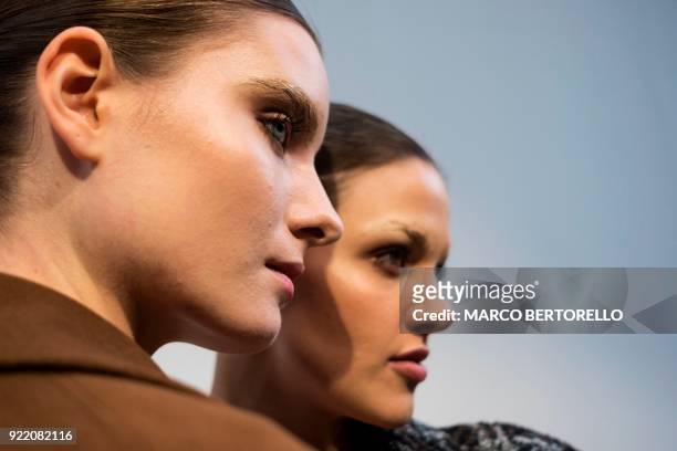 Models pose backstage prior to the women's Fall/Winter 2018/2019 collection fashion show by Lucio Vanotti in Milan, on February 21, 2018. / AFP PHOTO...