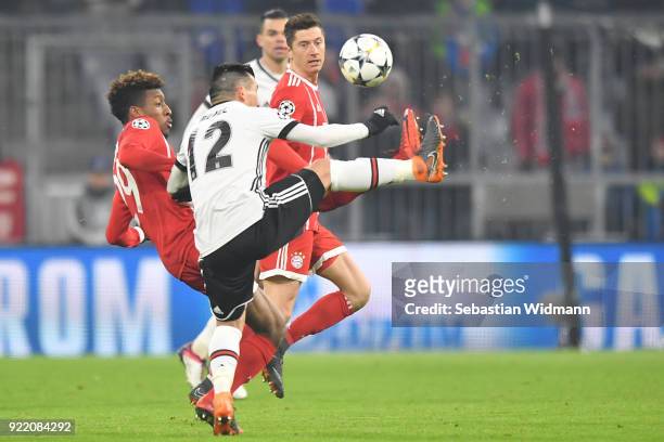 Kingsley Coman of Bayern Muenchen and Gary Medel of Besiktas compete for the ball as Robert Lewandowski of Bayern Muenchen watches during the UEFA...
