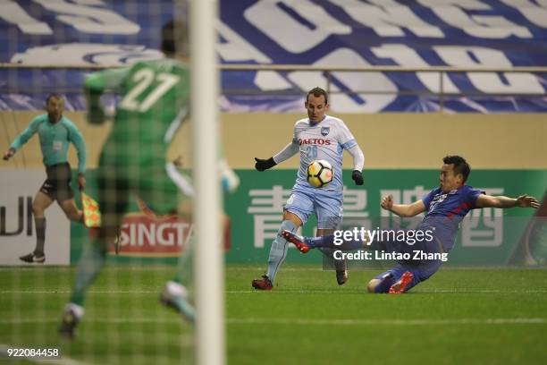 Luke Wilkshire of Sydney FC in action with Li Yunqiu of Shanghai Shenhua FC during the AFC Champions League Group H match between Shanghai Shenhua FC...