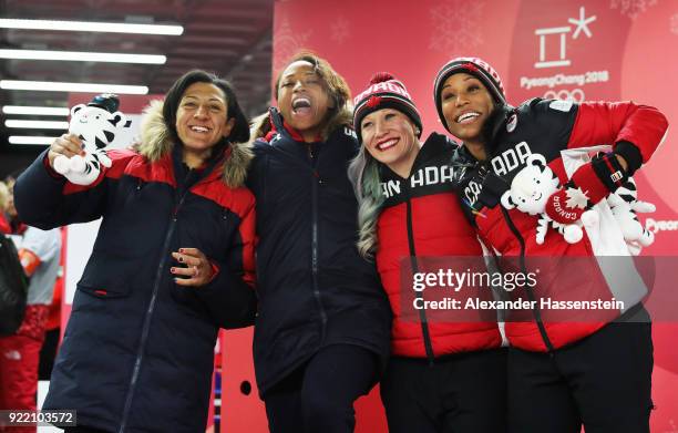 Elana Meyers Taylor and Lauren Gibbs of the United States, silver, and Kaillie Humphries and Phylicia George of Canada, bronze, celebrate after the...