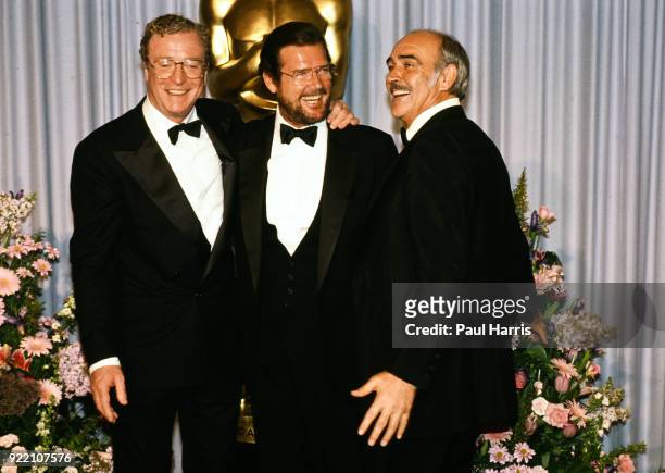 Michael Caine, Roger Moore and Sean Connery back stage at the 1989 Oscars March 29, 1989 Dorothy Chandler Pavilion, Los Angeles, California
