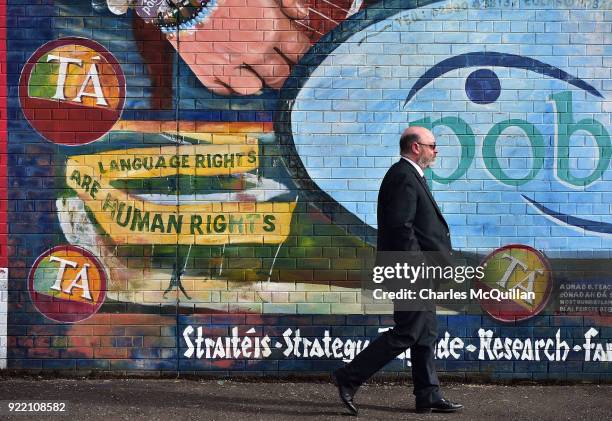 Man walks past a mural promoting Irish language rights on February 21, 2018 in Belfast, Northern Ireland. Talks to restore the Northern Ireland power...