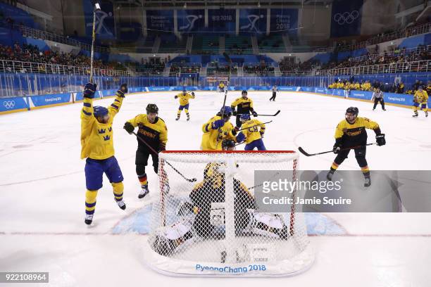 Team Sweden reacts afer scoring a goal in the third periord against Germany during the Men's Play-offs Quarterfinals game on day twelve of the...