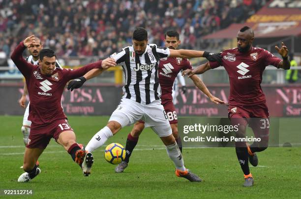 Sami Khedira of Juventus is challenged by Nicolas Burdisso and Nicolas N koulou of Torino FC during the Serie A match between Torino FC and Juventus...