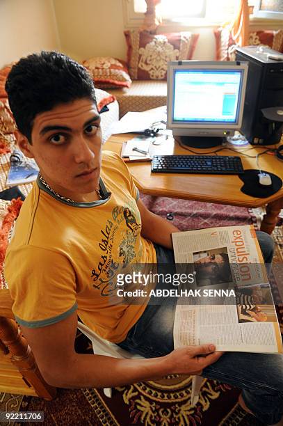 Year-old Moroccan Alae Eddine, deported from france 6 months ago, looks at a magazine article about him, at his home in Sidi Slimane, some 120 kms...
