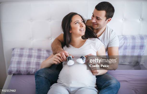 father can't wait to play with his baby - baby booties stock pictures, royalty-free photos & images