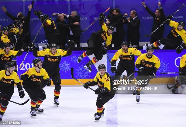 Germany players celebrate their victory after the men's quarter-final ice hockey match between Sweden and Germany during the Pyeongchang 2018 Winter...