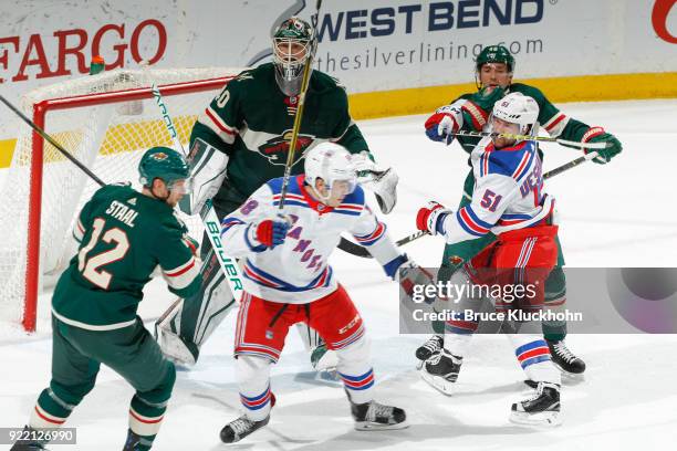 Eric Staal, Zach Parise and Devan Dubnyk of the Minnesota Wild defend against David Desharnais and John Gilmour of the New York Rangers during the...