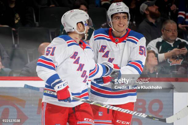 John Gilmour celebrates his first career NHL goal with David Desharnais of the New York Rangers against the Minnesota Wild during the game at the...