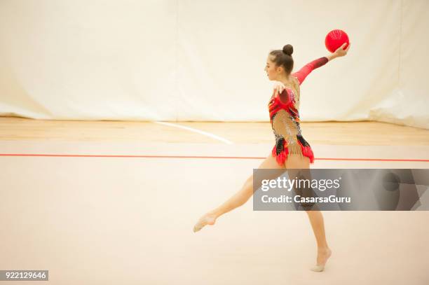 teenage rhythmic gymnastics athlete dancing with ball - rhythmic-gymnastics-ball stock pictures, royalty-free photos & images