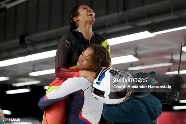 Mariama Jamanka of Germany celebrates with Lauren Gibbs of the United States in the finish area during the Women's Bobsleigh heats on day twelve of...