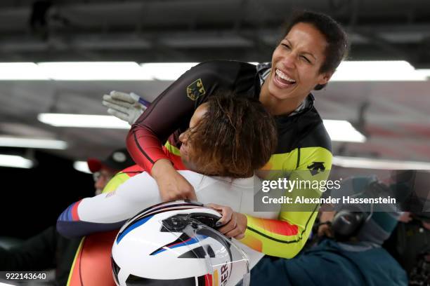 Mariama Jamanka of Germany celebrates with Lauren Gibbs of the United States in the finish area during the Women's Bobsleigh heats on day twelve of...