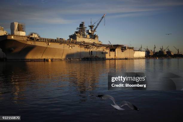 The USS Bataan Wasp-class amphibious assault ship sits docked at the BAE Systems Plc Norfolk Ship Repair facility on the Elizabeth River in Norfolk,...