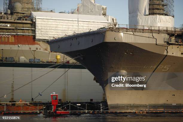 The USS Bataan Wasp-class amphibious assault ship sits docked at the BAE Systems Plc Norfolk Ship Repair facility on the Elizabeth River in Norfolk,...