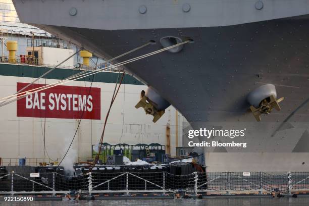 The USS Bataan Wasp-class amphibious assault ship sits docked in front of signage at the BAE Systems Plc Norfolk Ship Repair facility on the...